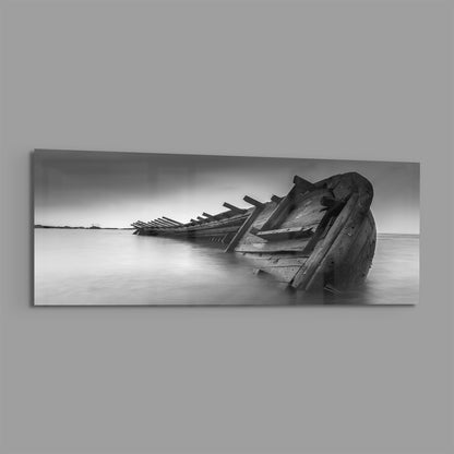 Black and white shipwreck panoramic glass print angled on a gray background