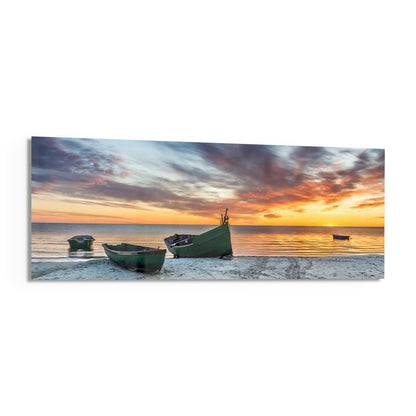Fishing boats at sunset beach panoramic glass print angled on a white background