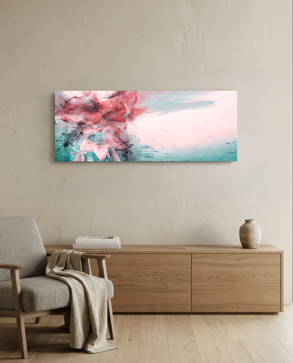 Coral and teal ink burst abstract glass wall art above a light oak sideboard beside a cream armchair