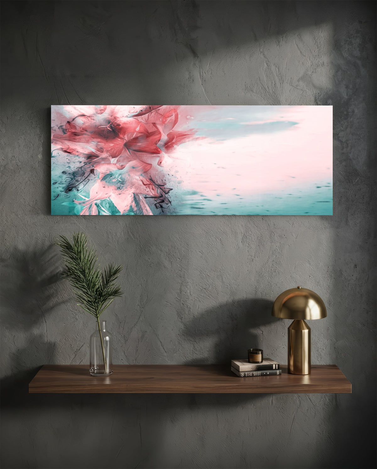 Coral and teal ink burst abstract glass wall art above a floating walnut shelf with a brass lamp