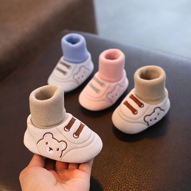 Baby cloth shoes with multiple color sock options displayed together on surface