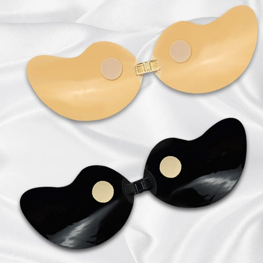 Beige and black invisible bra for deep v dress pads on a white fabric background