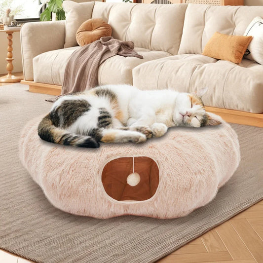 Beige plush cat tunnel bed with sleeping cat on top and peekaboo entrance below
