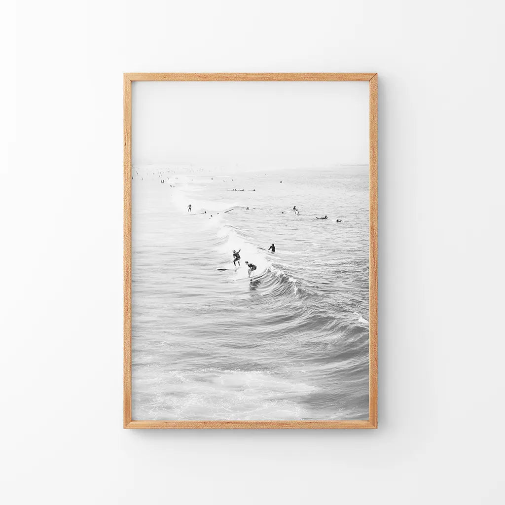 Black and white surfers on the waves coastal wall art print