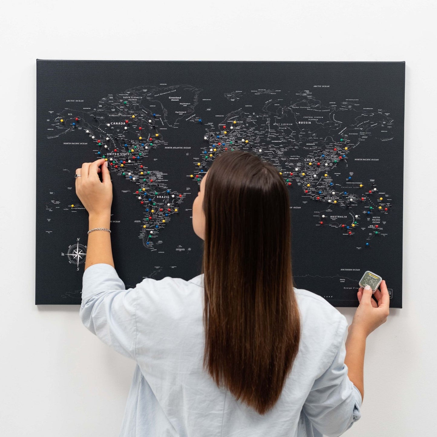 Black world map canvas wall art in a pine wood frame