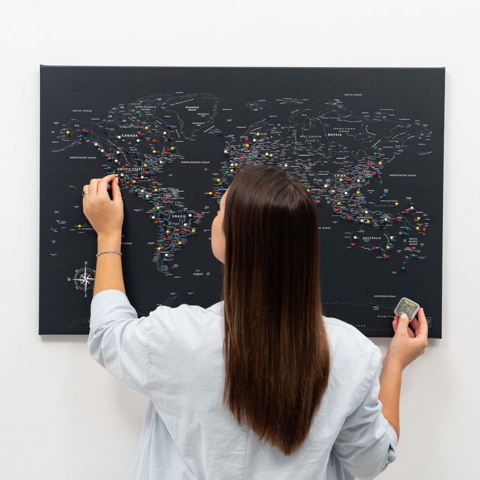 Black world map canvas wall art in a pine wood frame