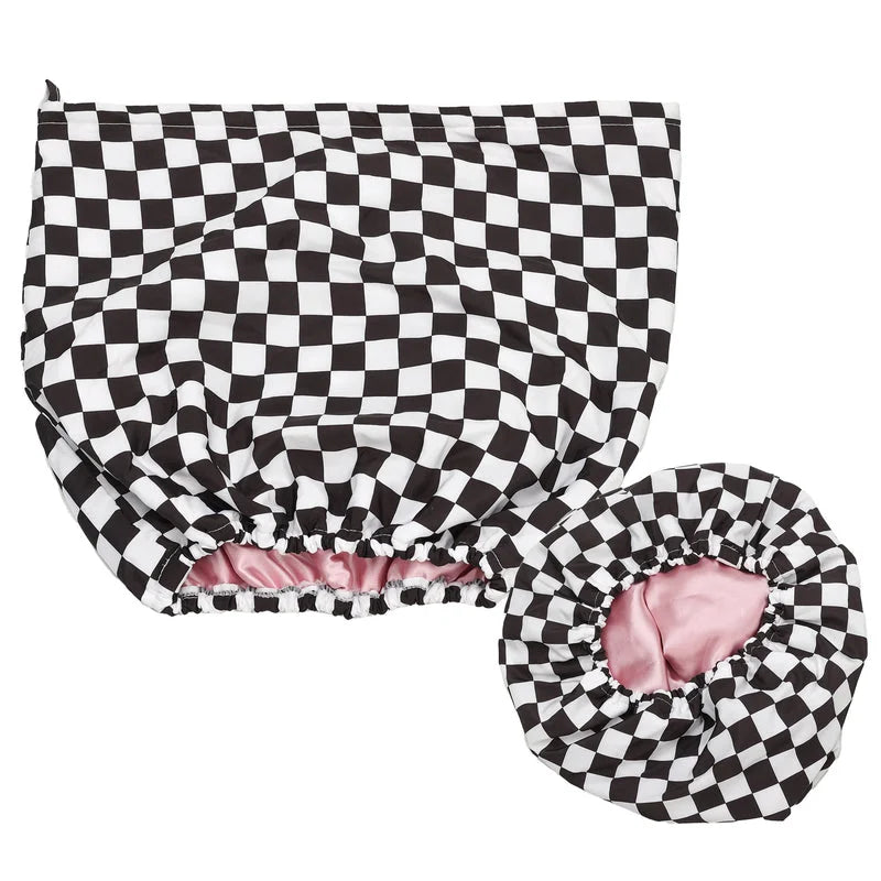Black and white checkered waterproof shower cap with pink satin interior and elastic edge