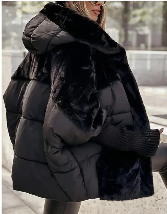 Black faux fur winter coat for women shown from the back with plush textured detailing