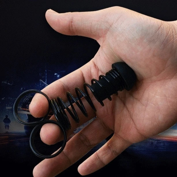 Black spring-loaded finger grip strengthener with silicone loops held in hand