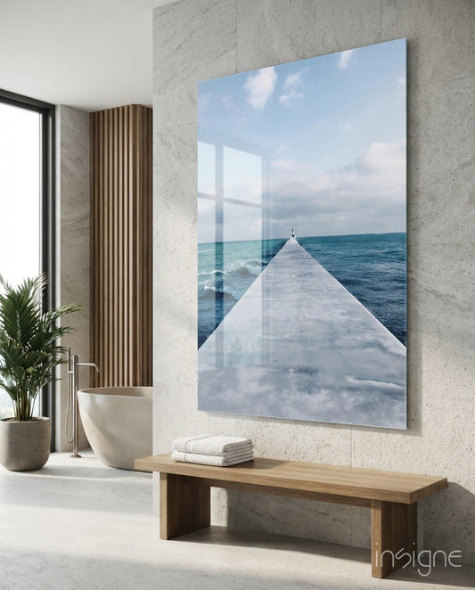 Dock glass wall art, weathered concrete pier over cobalt ocean toward a cloud-streaked horizon