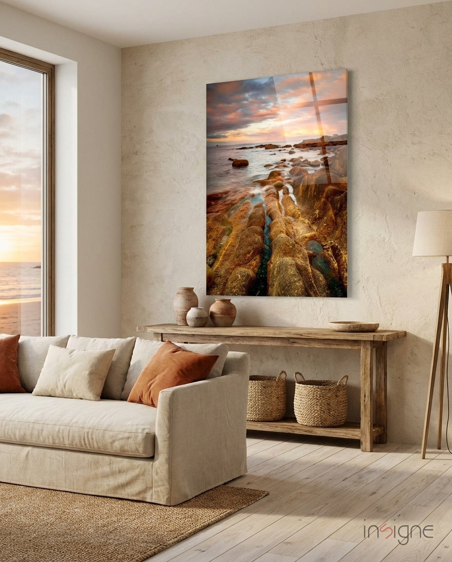 Golden rocky coast at sunset glass wall art