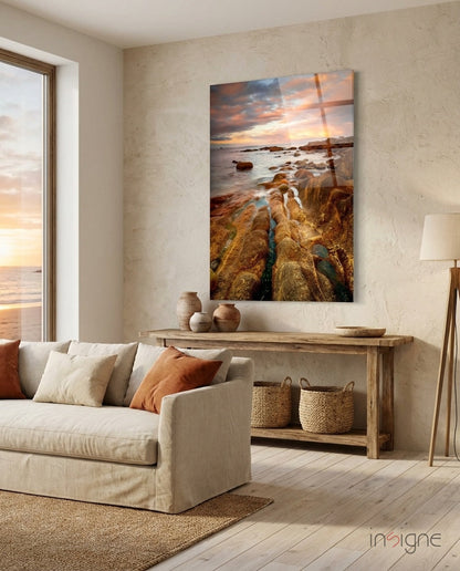 Golden rocky coast at sunset glass wall art