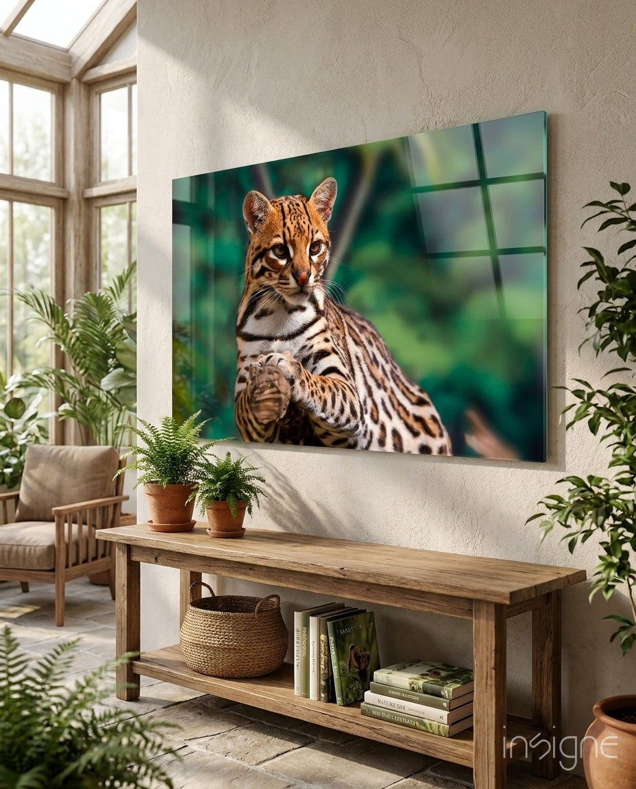 Spotted wild cat glass wall art with golden eyes on emerald jungle blur