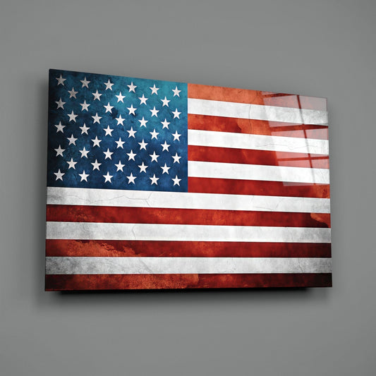 Weathered American flag glass wall art on a gray wall with a window reflection across the glossy glass