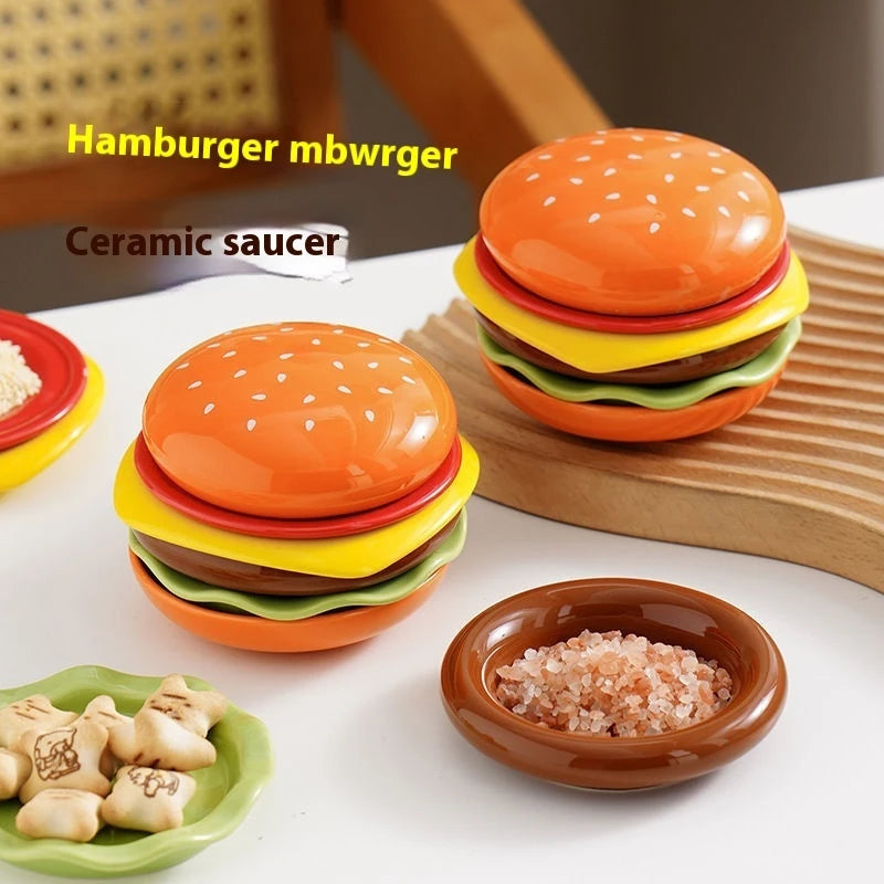 Ceramic hamburger set with a ceramic saucer on a white surface.