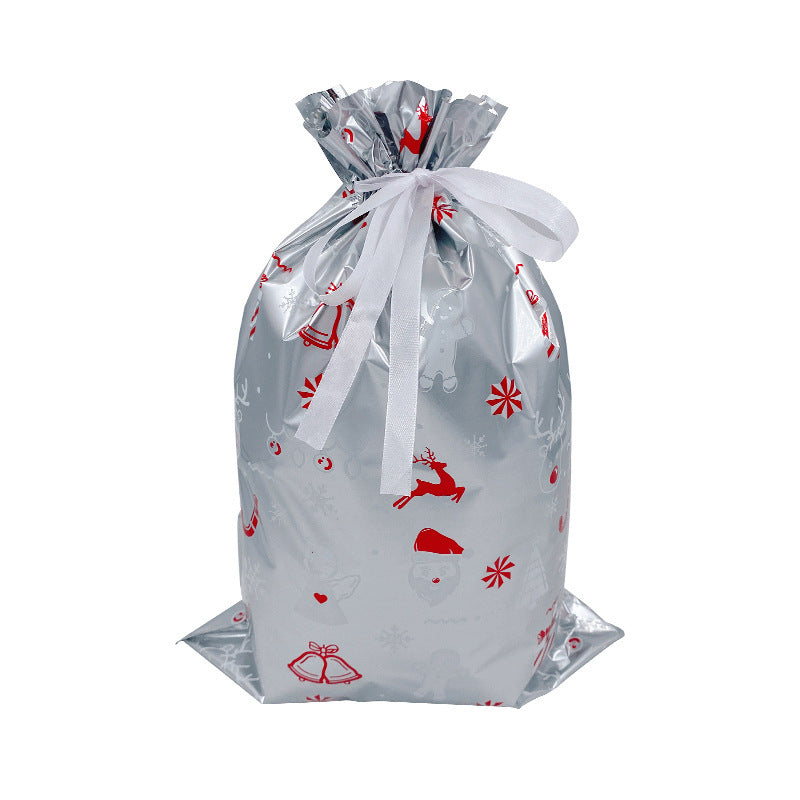 Clear gift bag with red holiday patterns tied with a white ribbon on a white background