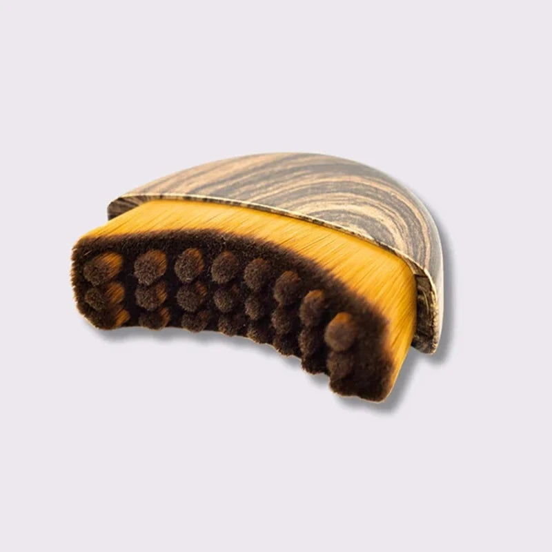 Close-up contoured lymphatic drainage face brush showing soft bristle design fits jawline curves precisely