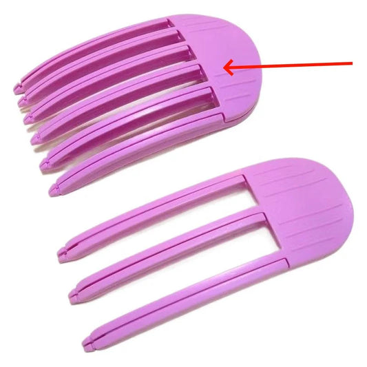 Close-up of pink plastic hair root volume clips featuring curved comb teeth design for crown lifting