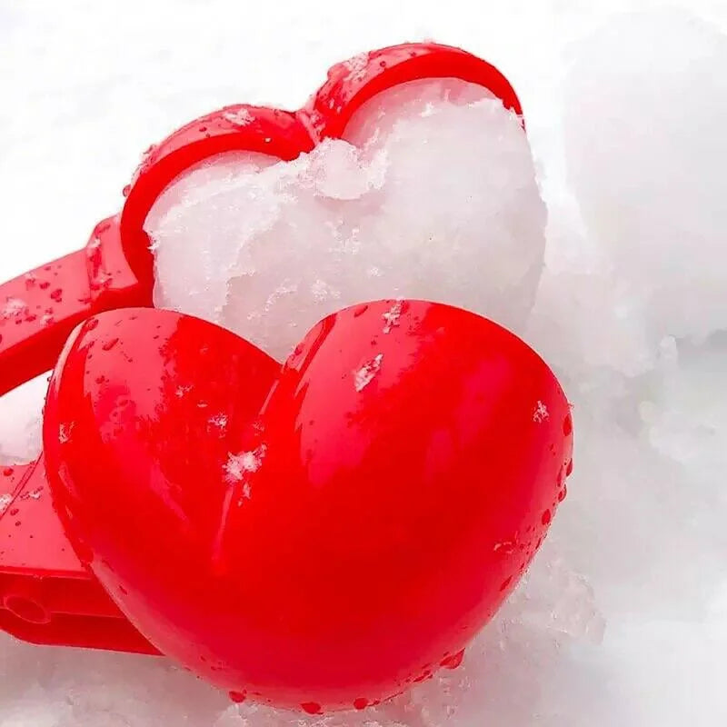 Close-up of red heart snowball clip forming compact snow heart shape