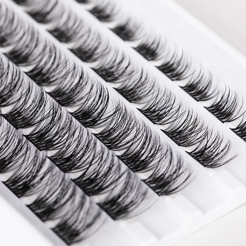 Close up view of lightweight double headed eyelash clusters arranged in rows for DIY lash extension