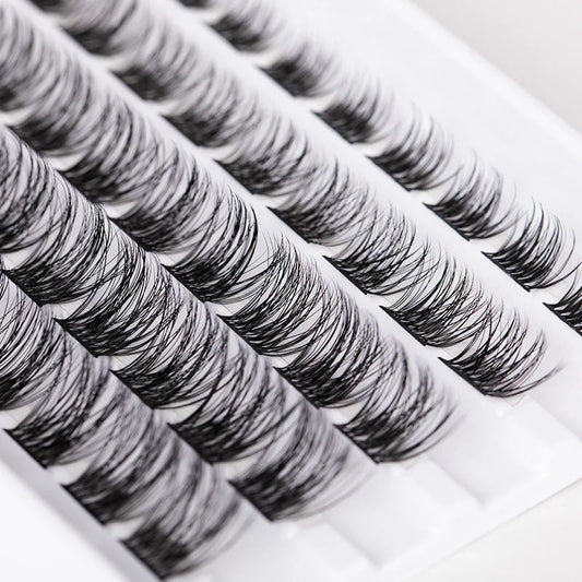 Close up view of lightweight double headed eyelash clusters arranged in rows for DIY lash extension