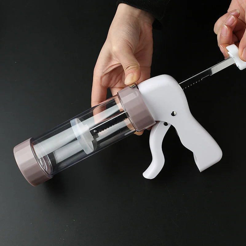 Cookie press gun being filled with dough hands demonstrating easy loading mechanism