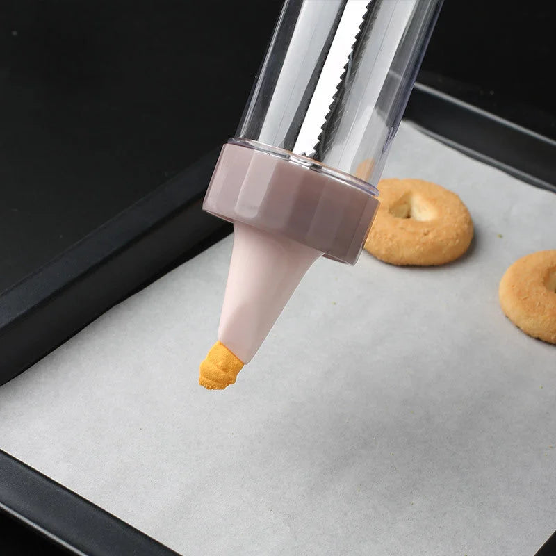 Cookie press gun piping cookie dough onto baking sheet with decorative shape