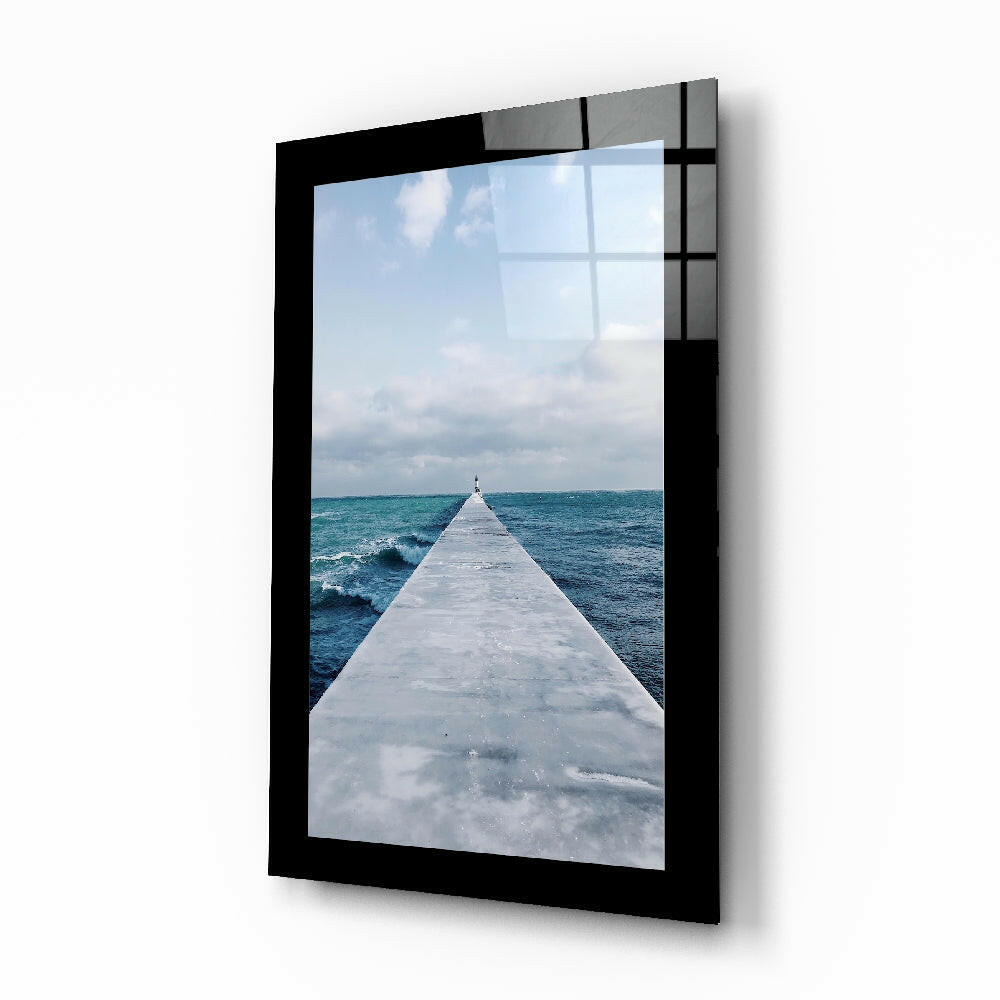 Far Horizon glass wall art with coastal pier and distant lighthouse