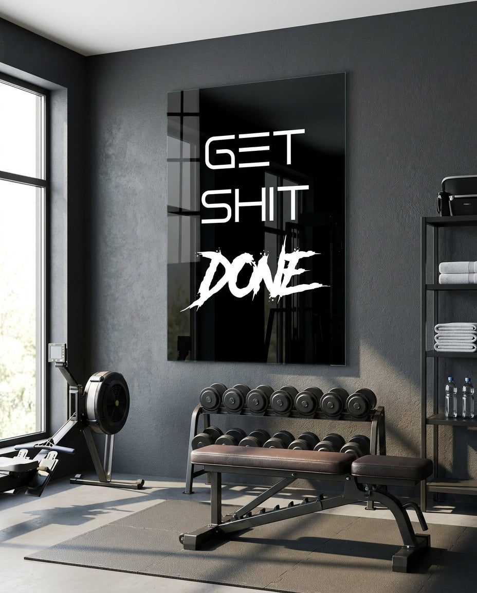Get Sh*t Done white brush script on black glass wall art in a home gym above a weight bench