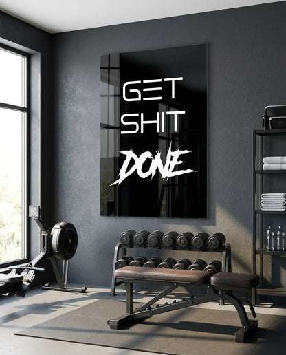 Get Sh*t Done white brush script on black glass wall art in a home gym above a weight bench