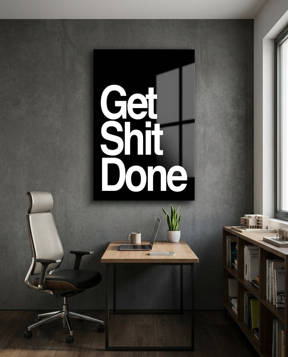 Get Sh*t Done bold white on black glass wall art in a home office above a desk and mesh chair