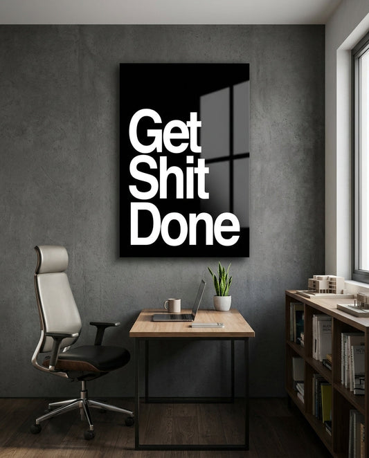 Get Sh*t Done bold white on black glass wall art in a home office above a desk and mesh chair