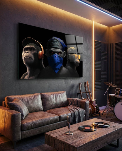 Three monkeys glass wall art in a dark music lounge above a leather sofa, guitars, a drum and vinyl records on a table