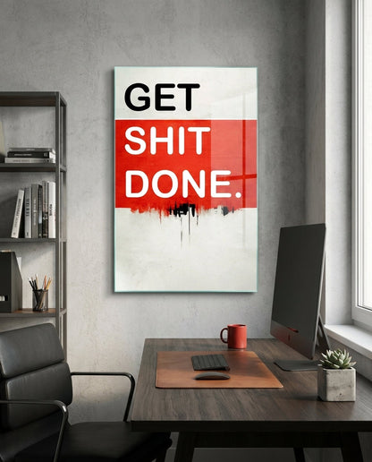 Red Band Drip Get Sh*t Done glass wall art in a gray home office above a desk with a monitor and a black chair
