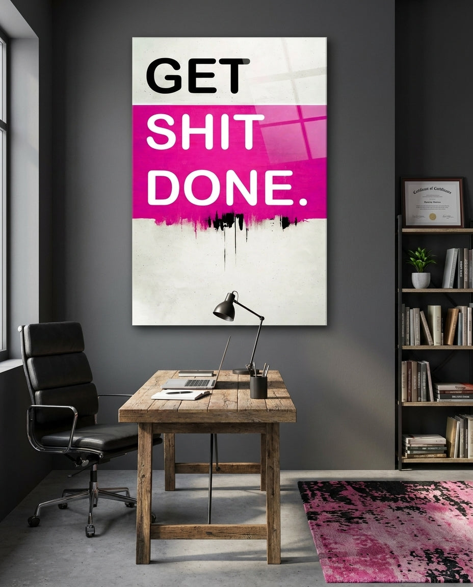 Get Sh*t Done hot pink glass wall art above a wooden desk with a black office chair and a pink rug
