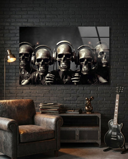Five skulls in headphones glass wall art on a black brick wall above a leather armchair and an electric guitar