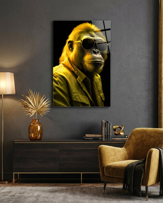 Yellow gorilla in aviator sunglasses glass wall art above a dark sideboard beside a mustard armchair and floor lamp