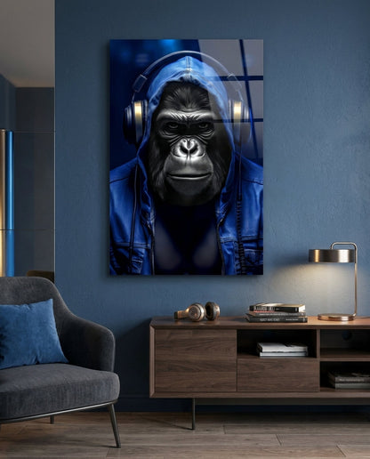 Blue hooded gorilla glass wall art on a blue wall above a wooden sideboard beside a gray armchair