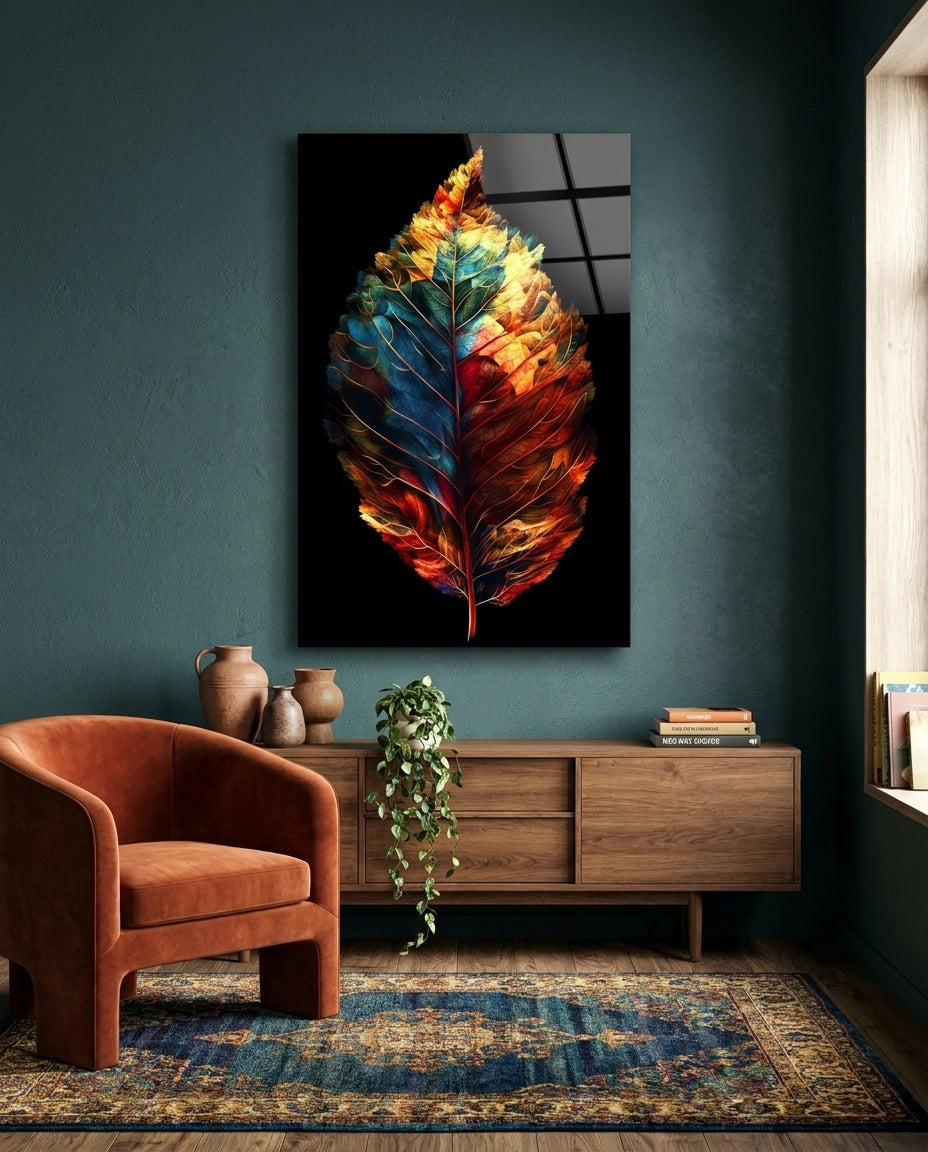 Two tone autumn leaf glass wall art on a dark teal wall above a wooden sideboard beside a rust armchair