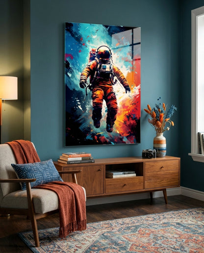 Orange suit astronaut glass wall art on a teal wall above a wooden sideboard beside a cream armchair