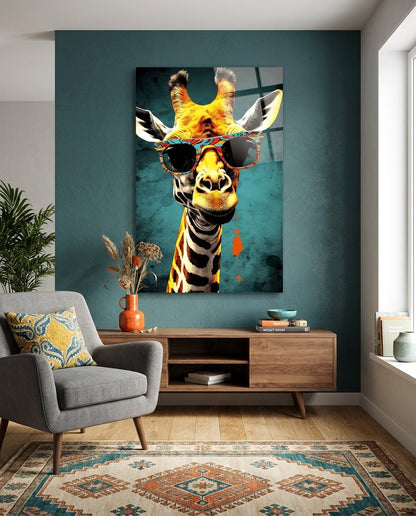 Giraffe in patterned sunglasses glass wall art on a teal wall above a wooden sideboard and gray armchair