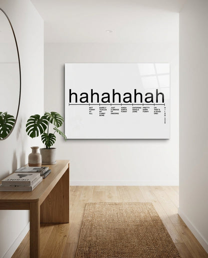 Laughter scale glass wall art in a white hallway above a wooden console table with a monstera plant