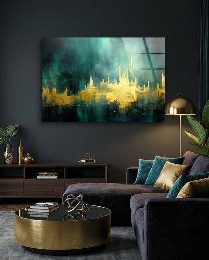 Gold and teal abstract skyline glass wall art above a charcoal sectional sofa and a brass drum table