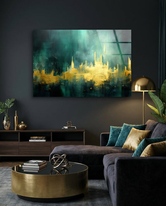 Gold and teal abstract skyline glass wall art above a charcoal sectional sofa and a brass drum table