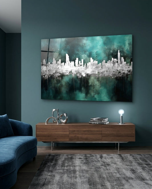 Teal and silver city skyline glass wall art above a walnut sideboard on a dark teal wall beside a blue sofa