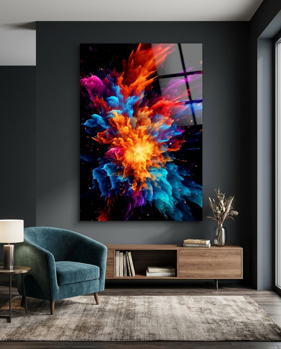 Fiery color burst abstract glass wall art on a dark gray wall above a low wooden sideboard beside a teal armchair