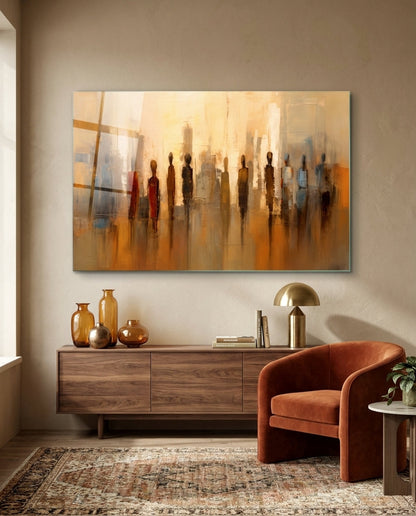 Amber standing figures glass wall art above a walnut sideboard beside a rust armchair