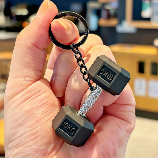 Dark gray 10KG mini dumbbell keychain charm with textured silver bar and black ring attachment