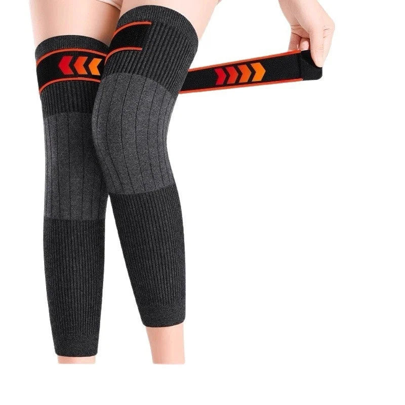 Dark gray thermal knee warmers with orange compression straps demonstrating adjustable fit and support system