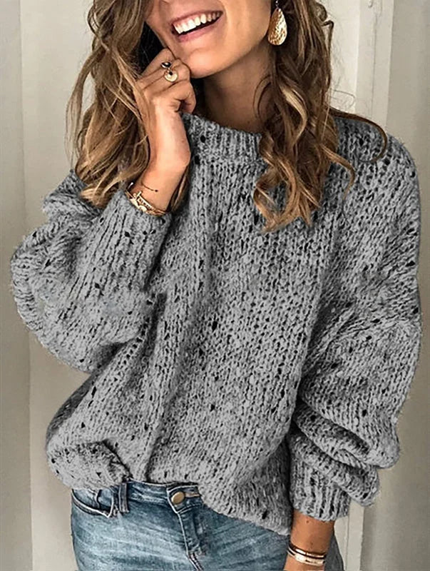 Dark grey women’s textured knit sweater styled with casual denim